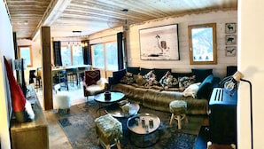 A cozy living room with a sofa, coffee table, and a dining area with chairs and a table. - Nice Chalet LEON located in Plangagnant (1650 m) La PLAGNE - LA ROCHE chairlift (Plangagnant)
