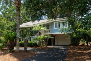 A two-story house with a covered porch and a garage.