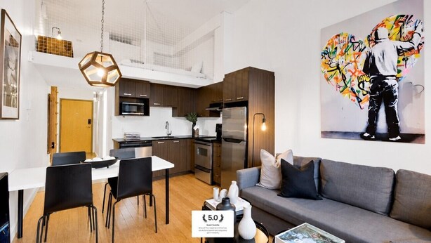 A modern apartment with a dining area, kitchen, and living room. - LiV MTL Main Plateau Urban Suites Near Downtown Montreal (Montréal)