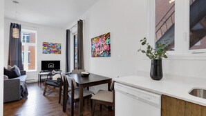 A modern apartment with a dining area, a living room, and a kitchen. - LiV MTL MTL Plateau Urban Suites Near Downtown Montreal (Montréal)