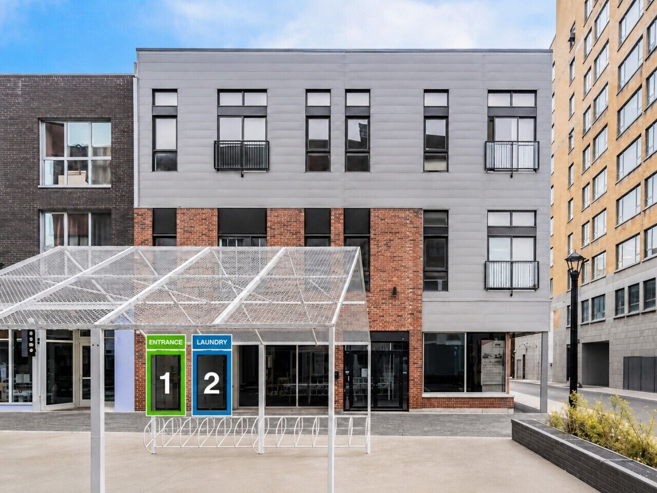 A modern building with a covered entrance and a laundry facility.
