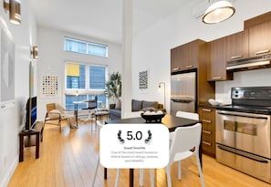 Enjoy meals in the kitchen with a refrigerator, oven, and dining area.