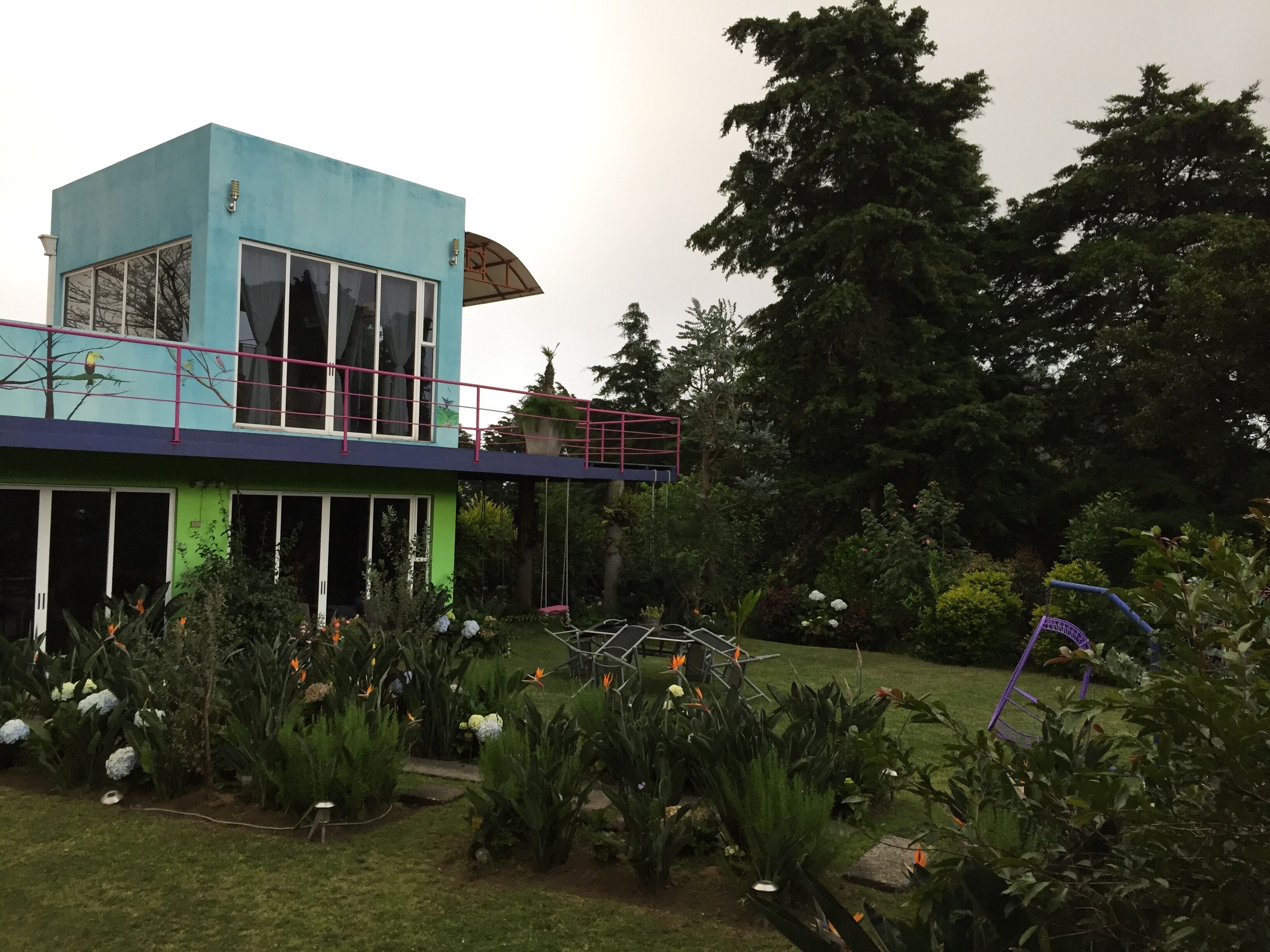 A modern two-story building with large windows and a balcony.