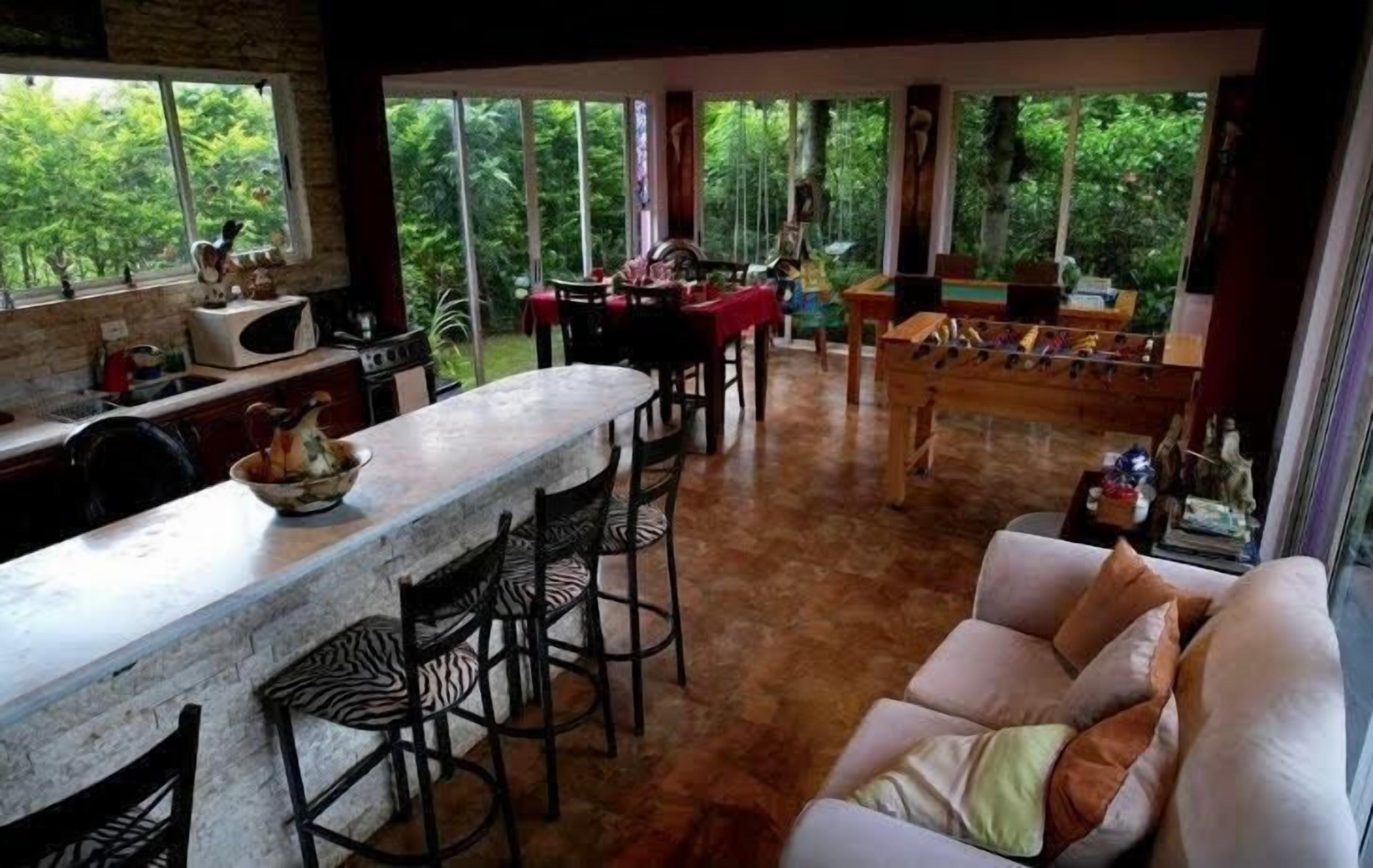 A spacious living area with a kitchen, dining table, and a sofa.