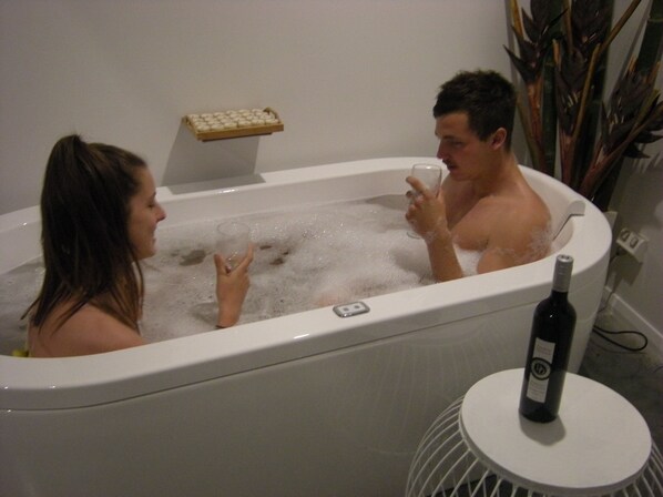 Bathtub, towels, soap, toilet paper