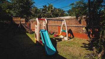A playground with a slide, swings, and a climbing structure.