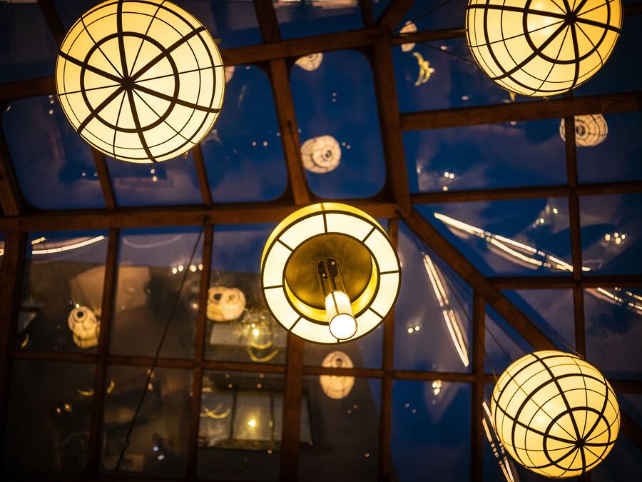 A ceiling with spherical light fixtures and a grid pattern.