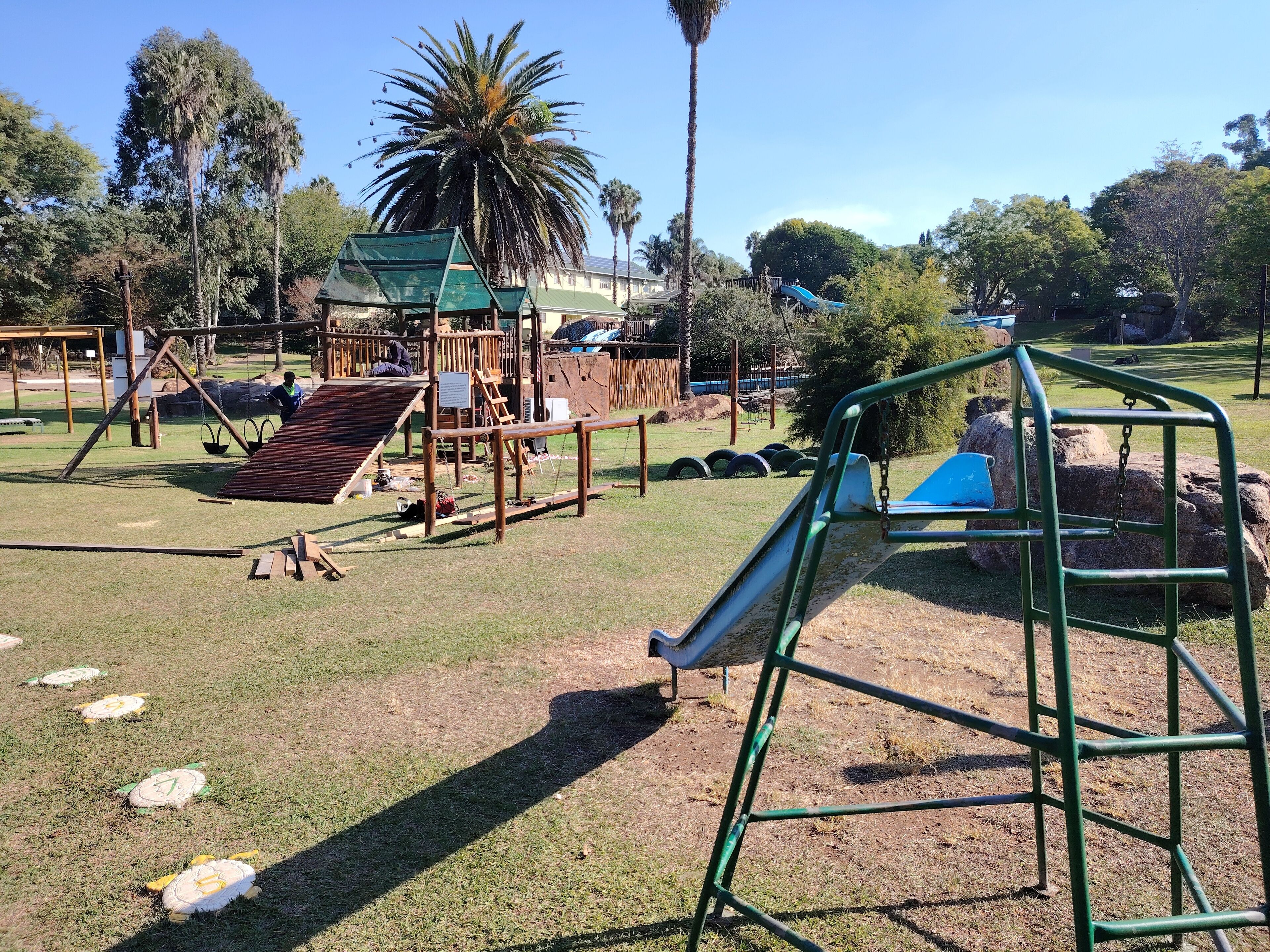 A playground with swings, slides, and climbing structures.