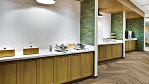 A modern bathroom with wooden cabinets, a white tiled wall, and a herringbone wood floor. - Fairfield by Marriott Inn & Suites Deerfield Beach Boca Raton (Deerfield Beach)