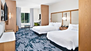 A hotel room with two beds, a desk, a chair, a TV, and a large window. - Fairfield by Marriott Inn & Suites Deerfield Beach Boca Raton (Deerfield Beach)