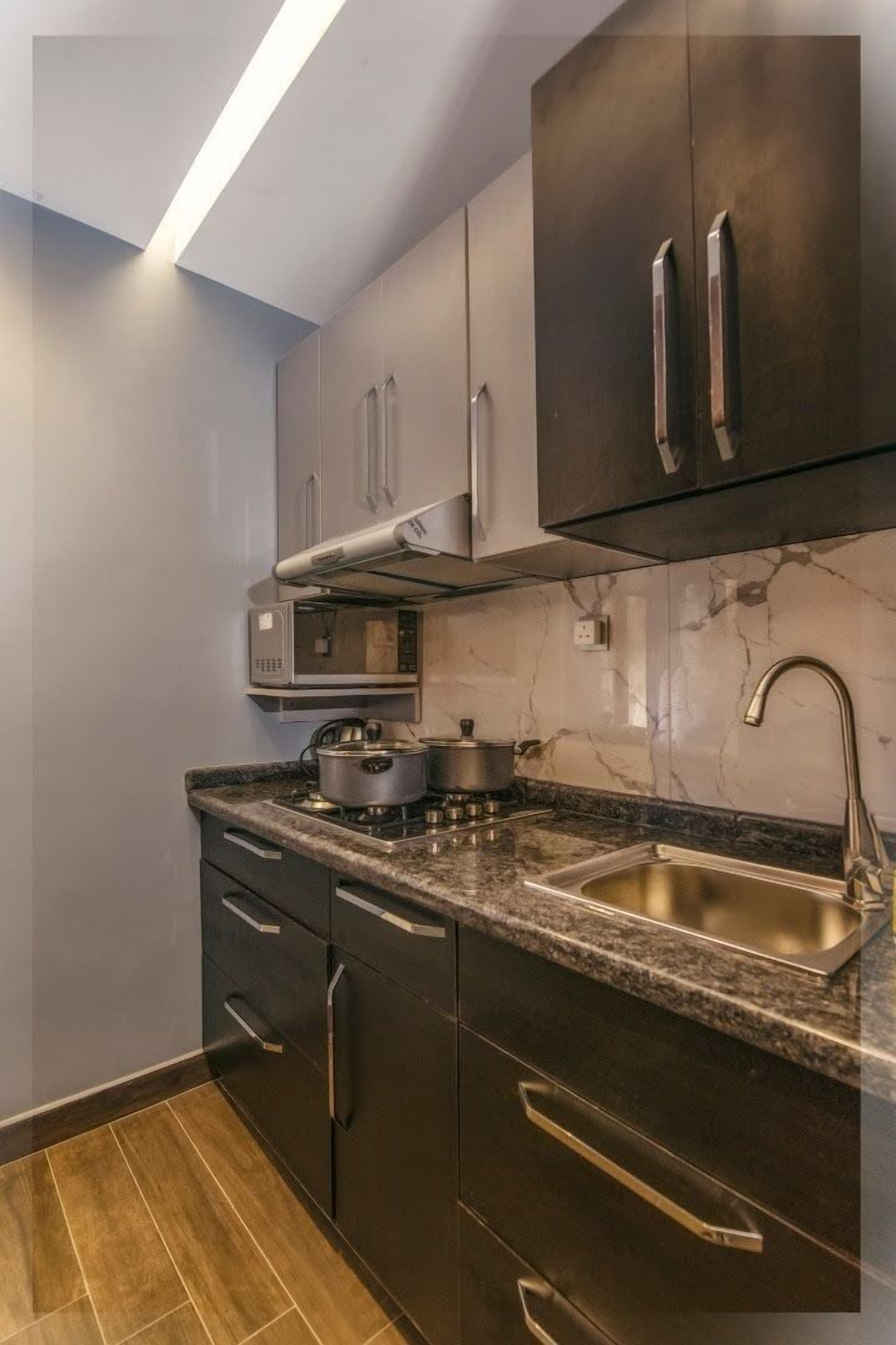 comfort suite, 1 bedroom | private kitchen | full-sized fridge, microwave, oven, stovetop