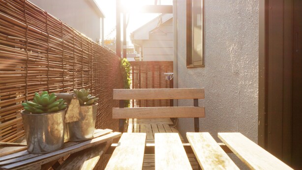 A wooden bench with metal planters containing succulents, a wicker fence, and a building with a window and a door. - Villa Traditional Designer House Shin Itabashi (Tokyo)