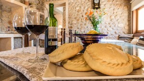 A table with wine glasses, a bottle of wine, and pastries. - Cas FRARE. Respecting roots with style (Buger)