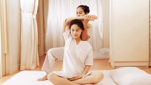 A person performing a stretching exercise on a mat in a room with a bed and curtains. - 2 Bed Majestic Villa Near Beach (Pattaya)