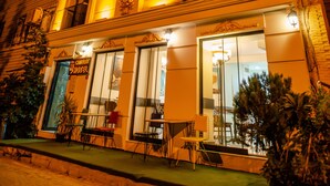 A hotel with a classic facade, large windows, and outdoor seating area. - The Camelot Hotel (Istanbul)