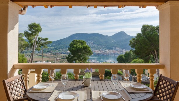 A table set for two with a view of a mountainous landscape and a body of water. - YourHouse Binifat, spacious house overlooking Puerto de Andratx (Andratx)
