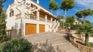 A two-story house with a balcony, a stone staircase, and a driveway. - YourHouse Binifat, spacious house overlooking Puerto de Andratx (Andratx)