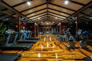 A gym with treadmills, stationary bikes, and exercise equipment. - Nayara Gardens (La Fortuna)