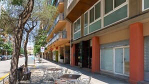 A street with outdoor seating, trees, and buildings with balconies. - matarolux2 · 25km from Barcelona , Beach 200 meters (Mataro)