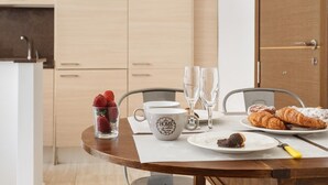 A dining table with a white mug, two glasses, a plate with pastries, and a glass of strawberries. - 25 km Barcelona , 100 meters from the beach (mat6) (Mataro)