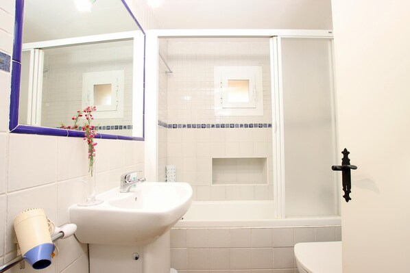 A bathroom with a sink, mirror, shower, and toilet. - PUNXA. Lovely stone-clad villa with large gardens surrounded by fruits and mountains (Pollensa)