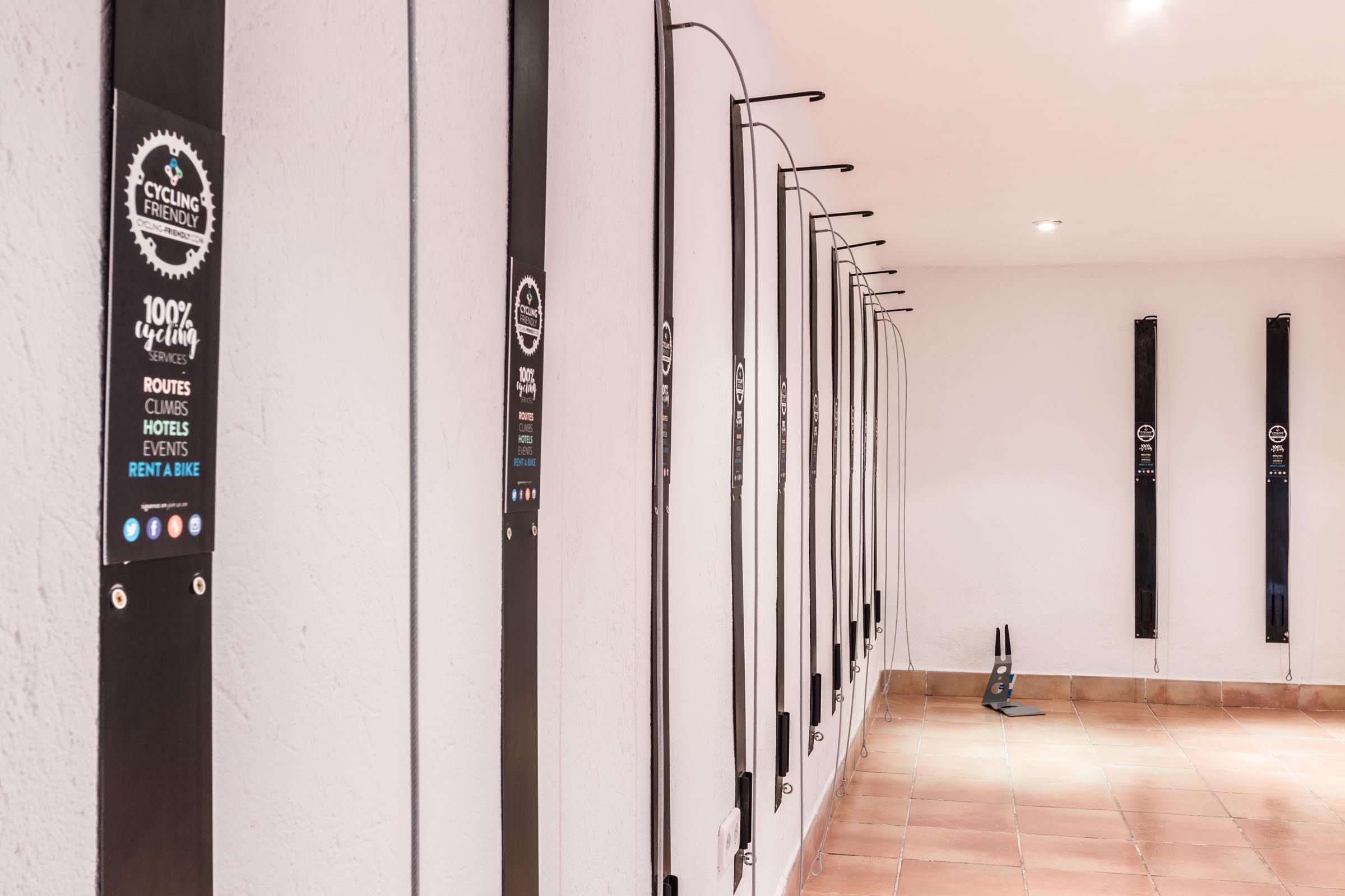 A hallway with a wall-mounted bike rental station and a row of bicycles.