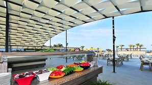 A buffet area with various food items and a seating area with tables and chairs. - Afytos Kazdaglari Akcay (Edremit)