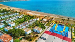 A coastal resort with multiple bungalow-style accommodations, a central swimming pool, and a beach area. - Afytos Kazdaglari Akcay (Edremit)
