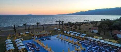 Seasonal outdoor pool, open 10:00 AM to 6:00 PM, pool umbrellas