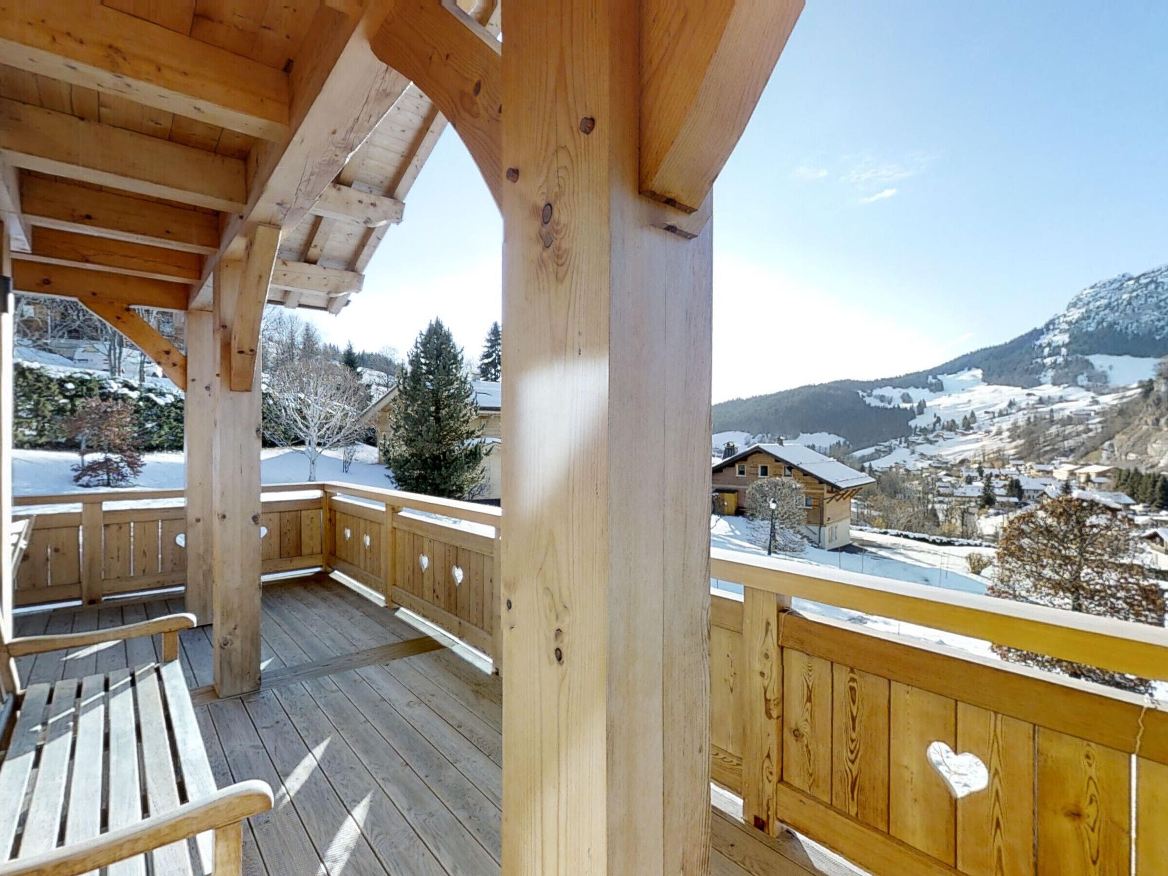 A wooden deck with a view of a snowy mountain landscape.