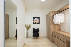 A modern bathroom with a wooden vanity, a black chair, and a wall-mounted towel rack. - Sun Moon Apartment 2 in the center of Rethymno town (Rethymno)
