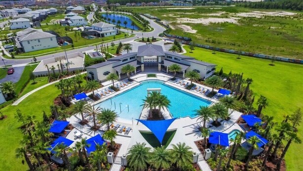 A large resort with a central swimming pool, multiple guest villas, and a well-maintained lawn. - 2619ca 10 Bedroom Villa by Redawning (Kissimmee)