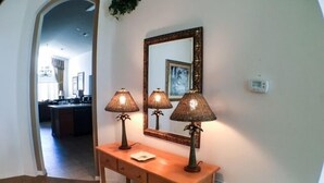 A wooden console table with two lamps and a mirror. - South Facing Pool Great For Families! 4 Bedroom Home by RedAwning (Haines City)