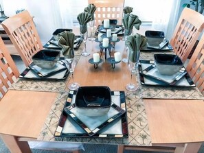A dining table set with square plates, glasses, and folded napkins. - South Facing Pool Great For Families! 4 Bedroom Home by RedAwning (Haines City)