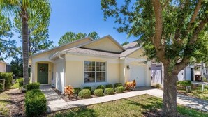 A single-story house with a front porch, a garage, and a well-maintained lawn.