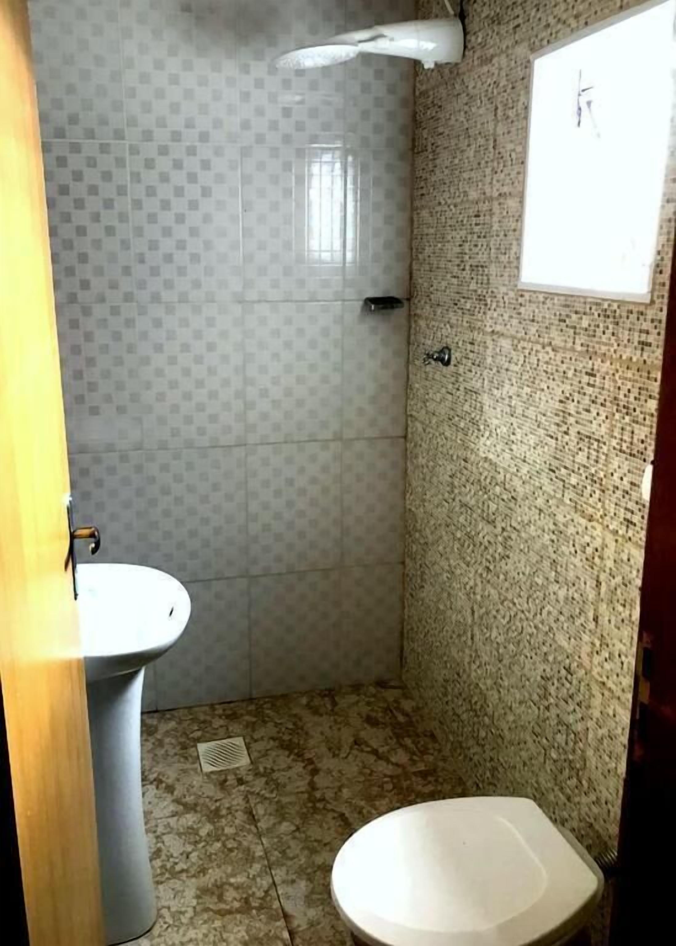 standard quadruple room | bathroom | shower, towels, soap, toilet paper