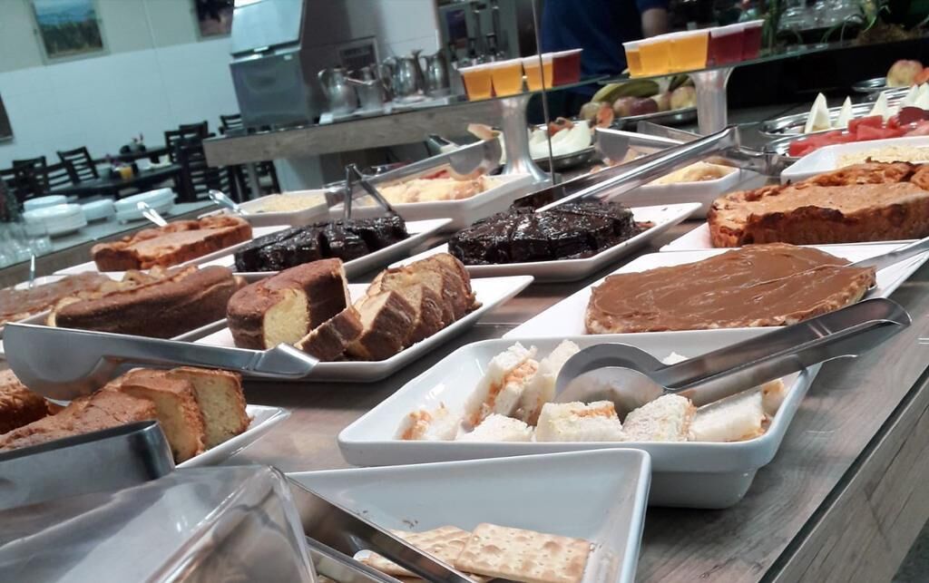 A buffet with various desserts including cakes and pastries.