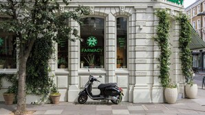 A building with a sign reading "FARMACY" and a parked scooter in front. - Lancaster Gate by Onefinestay (London)