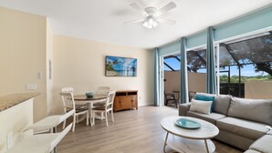 A spacious living area with a dining table, chairs, a sofa, and a ceiling fan. - Minutes to the Magic! 3-bedroom home, 6 minutes to Walt Disney World! (Kissimmee)