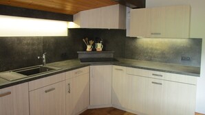 A kitchen with a sink, cabinets, and a countertop. - Spacious Savoyard chalet apt, equipped kitchen, 4 bedrooms, 2 baths, Le Chinaillon (Le Grand-Bornand)