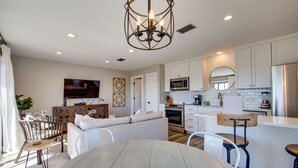 A modern kitchen with white cabinets, a stainless steel refrigerator, and a built-in microwave. - Your Private Inlet Beach Escape Awaits-Top Floor, Gulf Views, Community Pool (Inlet Beach)