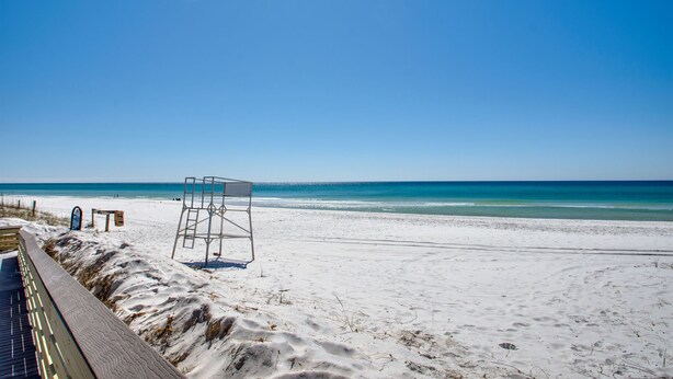A beach with a lifeguard tower, a wooden boardwalk, and a clear blue sky. - Your Private Inlet Beach Escape Awaits-Top Floor, Gulf Views, Community Pool (Inlet Beach)
