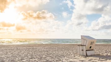 Relax in comfort on the beach with a designated chair, offering a serene ocean view.