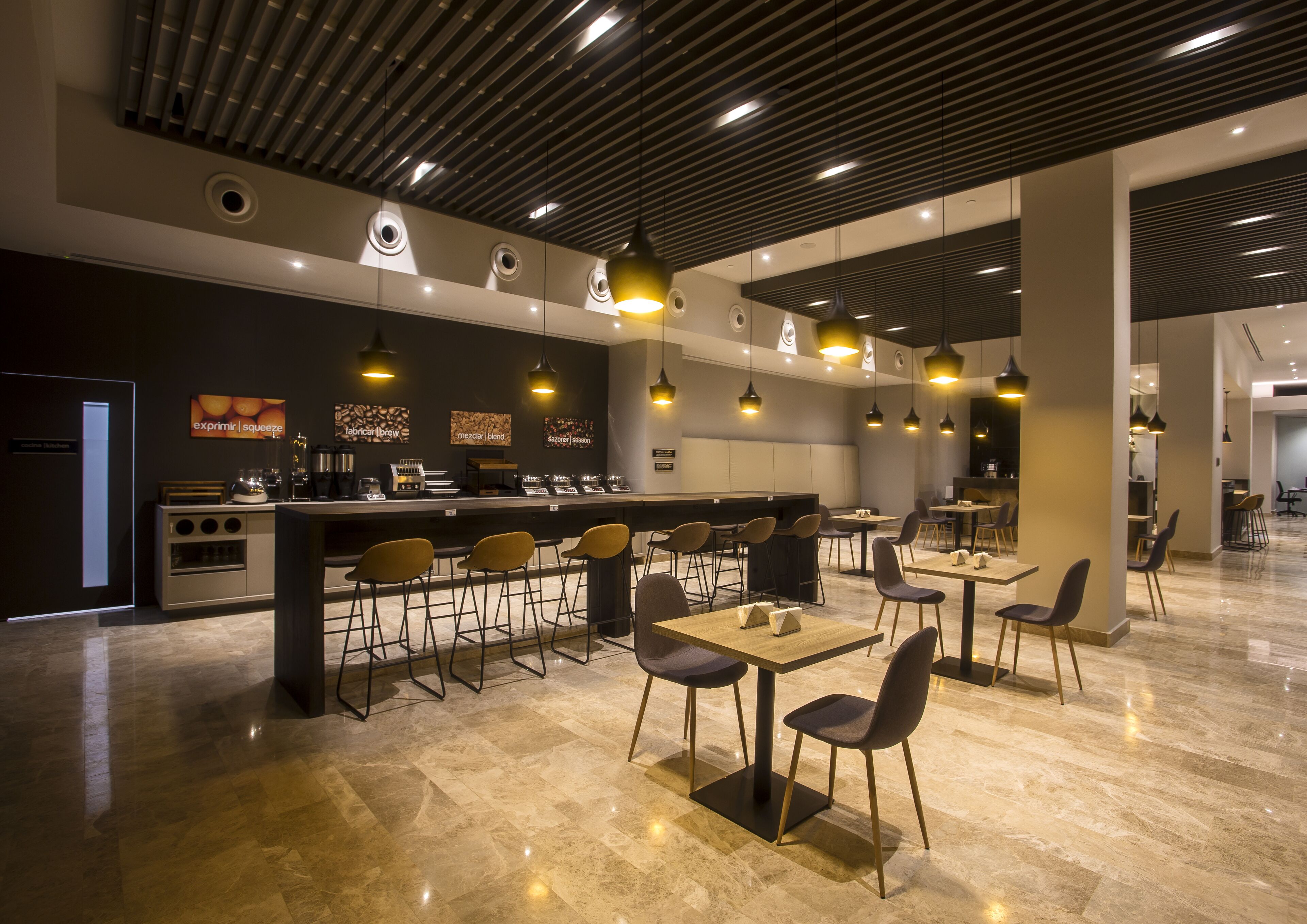 A modern cafe with a bar area, seating arrangements, and a clean, contemporary design.