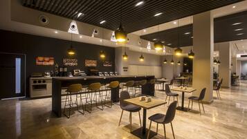 A modern cafe with a bar area, seating arrangements, and a clean, contemporary design.