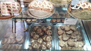 A bakery display with various baked goods including pies and cookies. - B&B Maia House (Santo Stefano di Camastra)