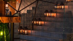 A modern staircase with glass railings and candle-lit lanterns. - Maison & Chateau Copsa (Karlovo)