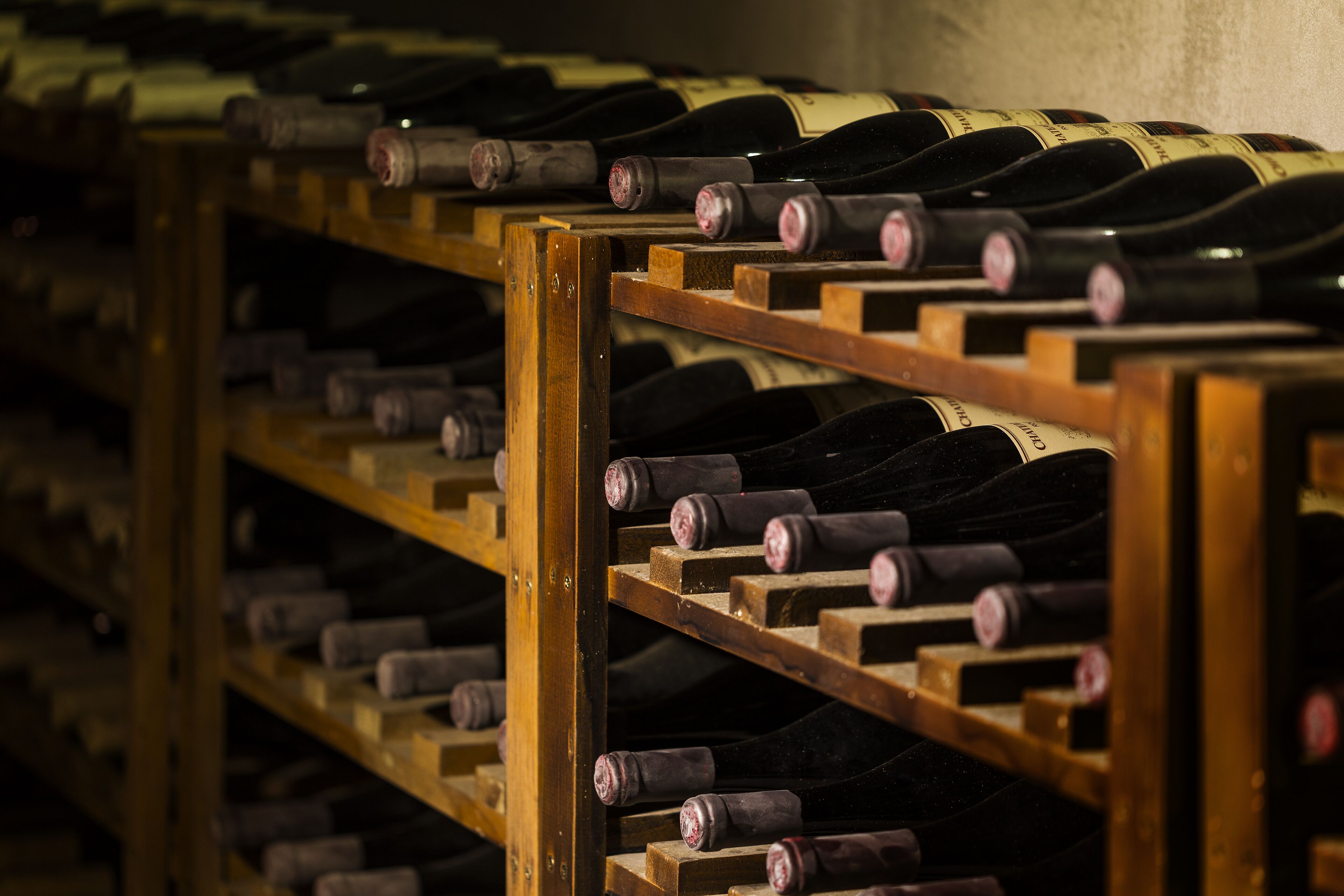 A wine rack with multiple bottles of wine.