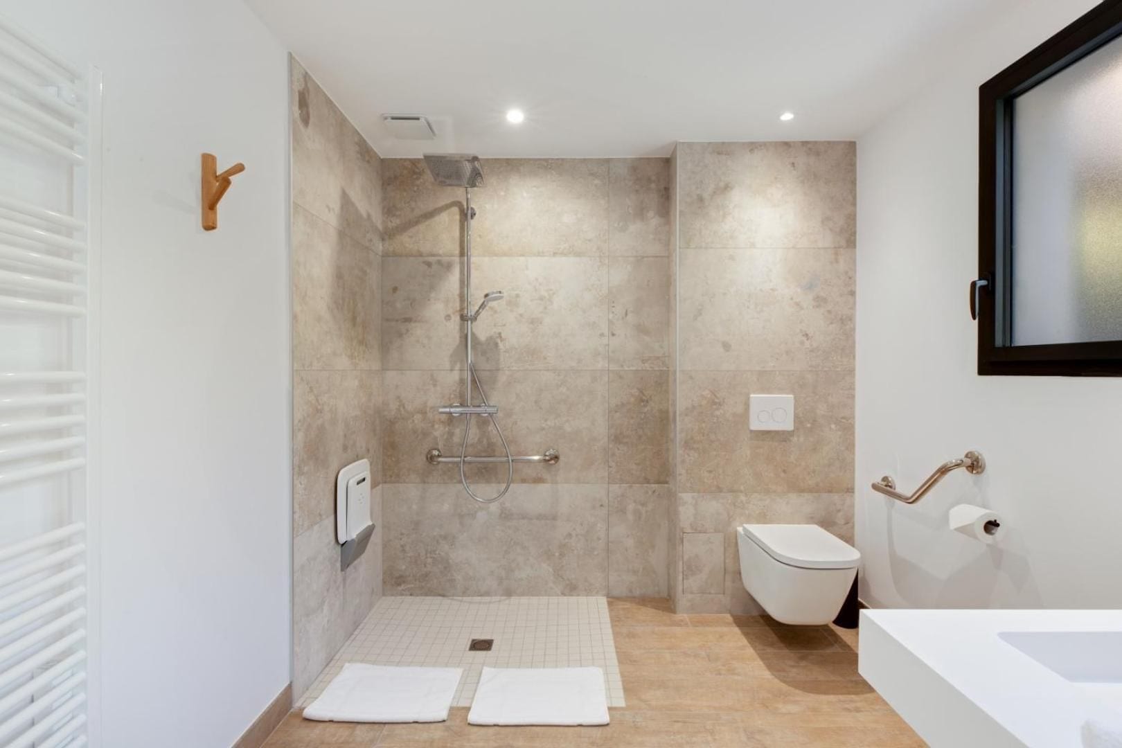 A modern bathroom with a shower, toilet, and bathtub.
