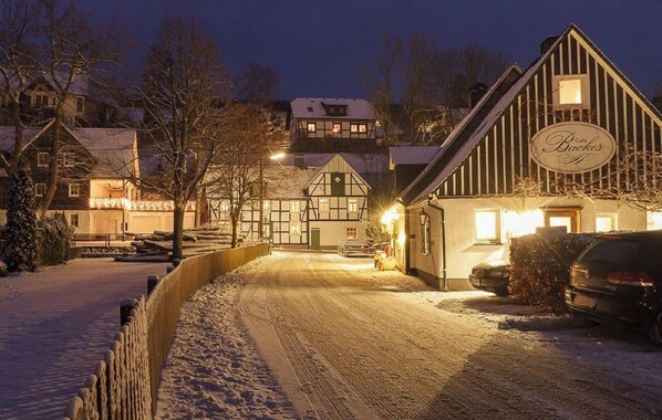 Experience the quaint charm of a traditional European village, where a cozy cafe and rustic buildings await discovery.